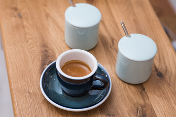Obraz na płótnie Canvas Delicious, aromatic and invigorating espresso coffee on the table in the cafeteria