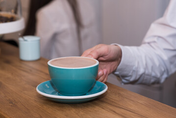 Barista guy gives delicious, aromatic and invigorating Americano coffee