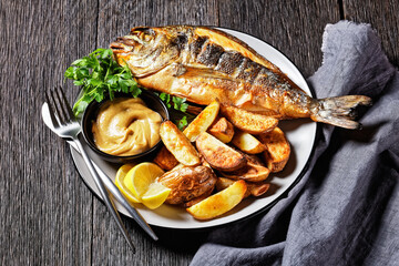 grilled fish with potato on a plate