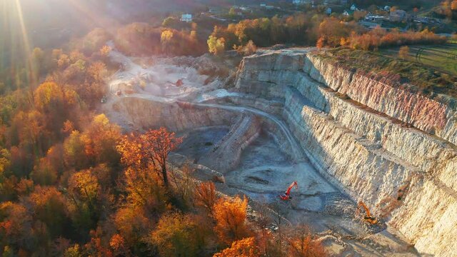 Limestone mine. Aerial view of the limestone mine with trucks and machines working in it. Caucasus Mountains in Russia