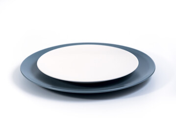Dish set - Large Navy Blue and small White plates isolated on white background side view, selective focus