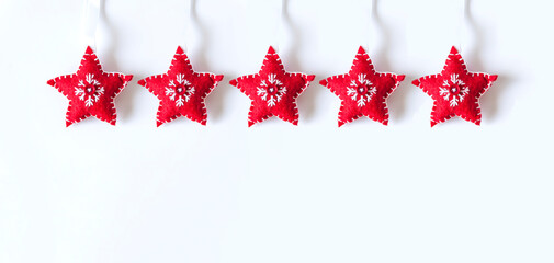Christmas or New year background with decor. Red soft stars with embroidery on white background
