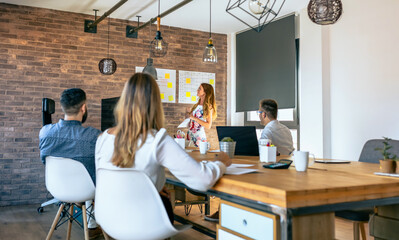 Female manager explaining in a work meeting to her workers