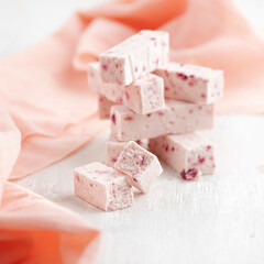 sweet confectionery Pastila with pieces of cranberry a on bright table.