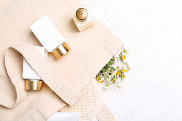 Fototapeta na wymiar Flat lay composition with chamomile flowers and cosmetic products on white table