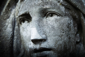 Virgin Mary. Fragment of very ancient stone statue. Religion, faith, suffering, love concept