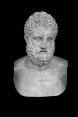 Ancient stone statue of powerful Hercules isolated on black backround..