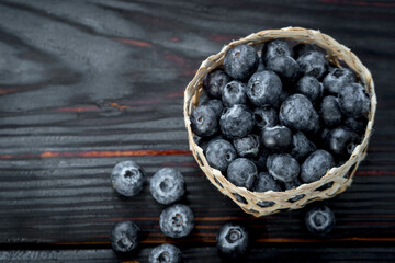 fresh ripe blueberries in a woven bamboo basket