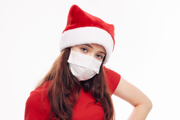 Fototapeta na wymiar girl wearing a medical mask santa hat cropped view new year holiday 
