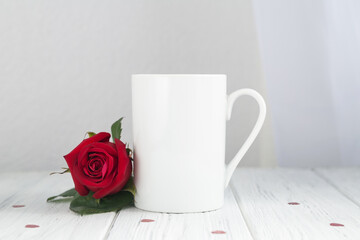 Valentines day coffee mug, cup on the wooden table and white background with red rose
