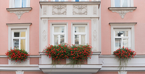 Obraz premium historic house front munich, pink facade, bay windows, stucco plaster