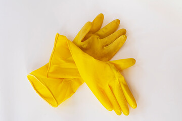 Household gloves. Dirty latex gloves. Yellow gloves for cleaning. Close-up. White background.