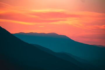 Naklejka na ściany i meble Sun setts over Caucasus Mountains. Joyful motivational bright colorful image. Georgia 