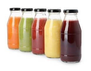 Bottles of fresh juices on white background