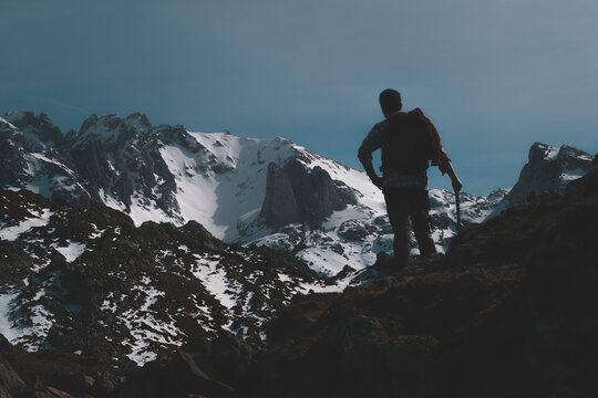 After many hours of hiking, hikers reach the snow-covered peaks of Europe in Asturias, Spain