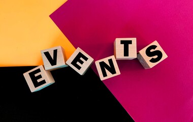 Event on a multi-colored background on wooden cubes.The concept of events .