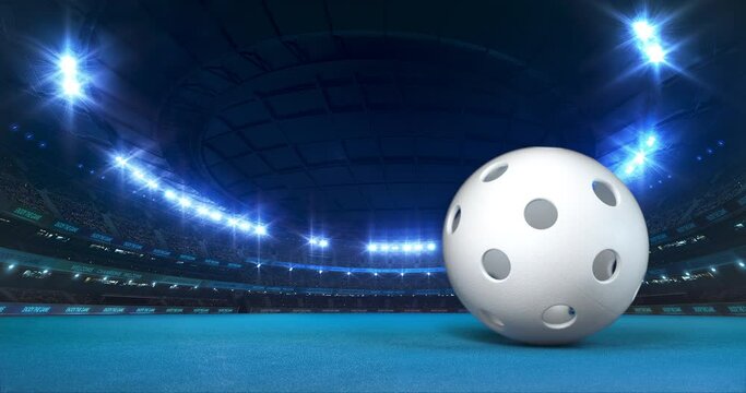 Modern Floorball Arena with shining lights and ball motion on the blue playground. Professional sport 4k video background edited as seamless loop.