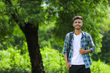 Naklejka na ściany i meble Young indian man showing expression over nature background