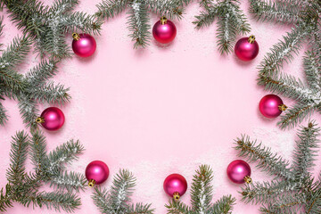 Fototapeta na wymiar Christmas decorations and fir tree on pink background