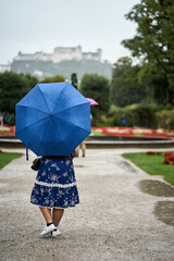 Obraz premium The castle Hohensalzburg seen from the Mirabellen garden in Salzburg, Austria on a rainy day