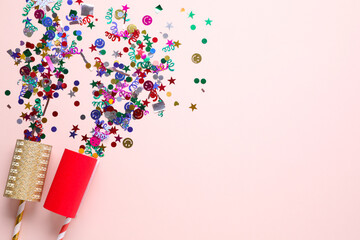 Flat lay composition of colorful confetti and party crackers on white background, space for text