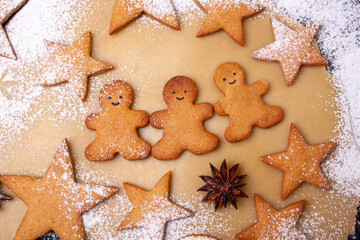 Baking Christmas gingerbread gingerbread man on the background of the dough. Festive delicious food