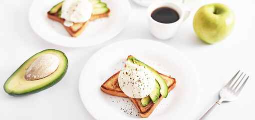 Toast with poached eggs and avocado. Healthy breakfast and food. Cozy morning. Nutrition for pregnant. Diet for women. Breakfast in hotel room or bed. Scrambled eggs sandwich.