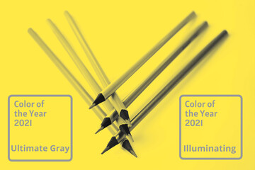 Abstract bright illuminating yellow and gray colours background with pencils.