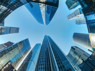 Futuristic view of the Moscow International Business Center Skyscrapers look-up panoramic view of modern city skyline with blue sky, office building exteriors with reflections in the glass walls 