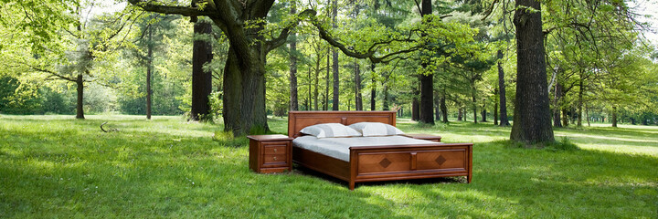 bed in a forest- concept of good sleep
