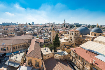Aerial view of the old city with blue sky of Jerusalem. Muristan street in Christian quarter and dome of  the Church of the Holy Sepulchre. View from the Lutheran Church of the Redeemer.