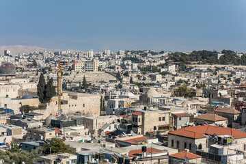 Aerial view of rooftops of the old city of Islamic quarter with blue sky of Jerusalem, with background of mosque of Al-Aqsa and Mount of Olives,  View from the Lutheran Church of the Redeemer.