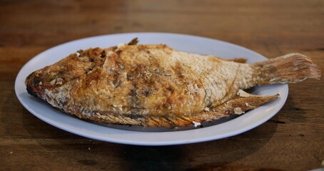 Tilapia grilled with salt on plate