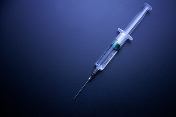 On dark blue background syringes. The concept of medicine and drug addiction