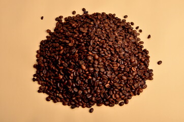 Round coffee beans stack on a beige background, copy space