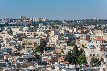 Fototapeta na wymiar Aerial view of rooftops of buildings in the old city with blue sky of Jerusalem. View from the Lutheran Church of the Redeemer.