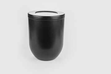 Black urn of human ashes for funeral on a white
