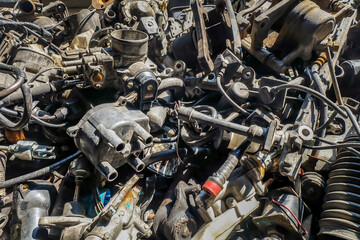 Close-up of Used and surplus car engines  & accessories of the car at the repair service garage. Selective focus.