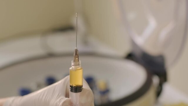 Platelet-Rich plasma preparation. Plasma in syringe. Centrifuge. Background