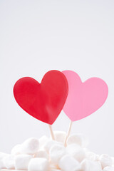 Red and pink hearts in marshmallow on white background