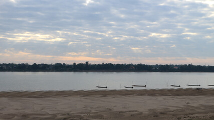 Long tail boats and sand dunes in the Mekong River