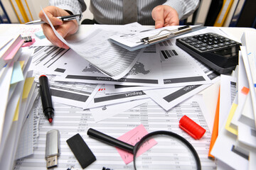business concept - businessman working with reports in office, table and workspace close view,...