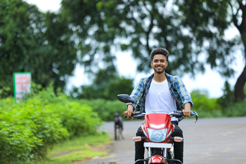 Young indian man enjoying motor bike riding