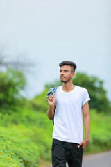 Young indian man showing expression over nature background