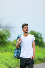 Young indian man showing expression over nature background