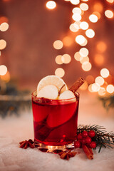 Christmas mulled red wine with aromatic spices and citrus fruits on a wooden rustic table, close-up. Traditional hot drink at Christmas time. High quality photo