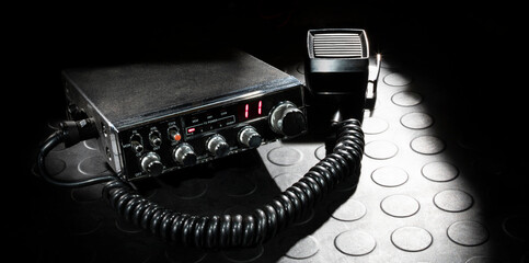Two way radio and microphone on a dark background