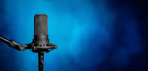 Microphone on blue background, broadcasting or podcasting banner with copy space