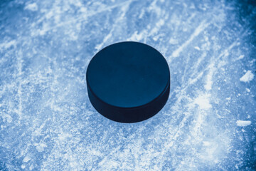 hockey puck lies on the snow macro