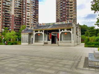 Small temple and tall residential buildings.  Guangzhou. Guangdong. China. Asia